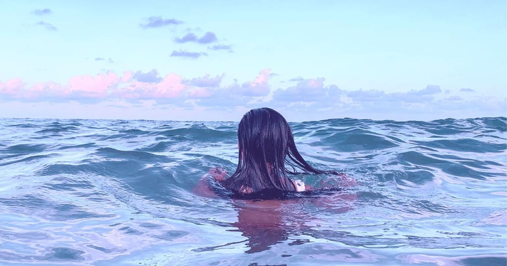 woman immersed in the sea for cold water therapy