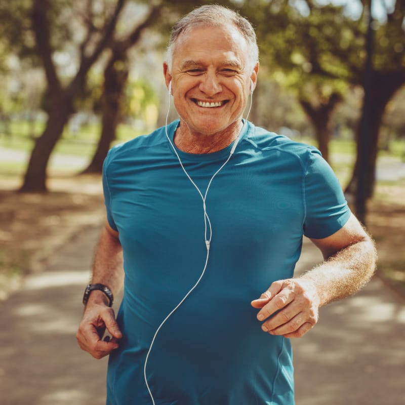 shop-australias-best-blood-test-4 A fit 60 year old man, smiling as he is running in nature listening to good music, probably something like Eye of the Tiger by Survivor.