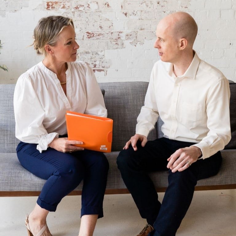 Optimise website images PORTRAIT - 12 practitioner jabe and health coach bee sitting on a couch discussing lab results.