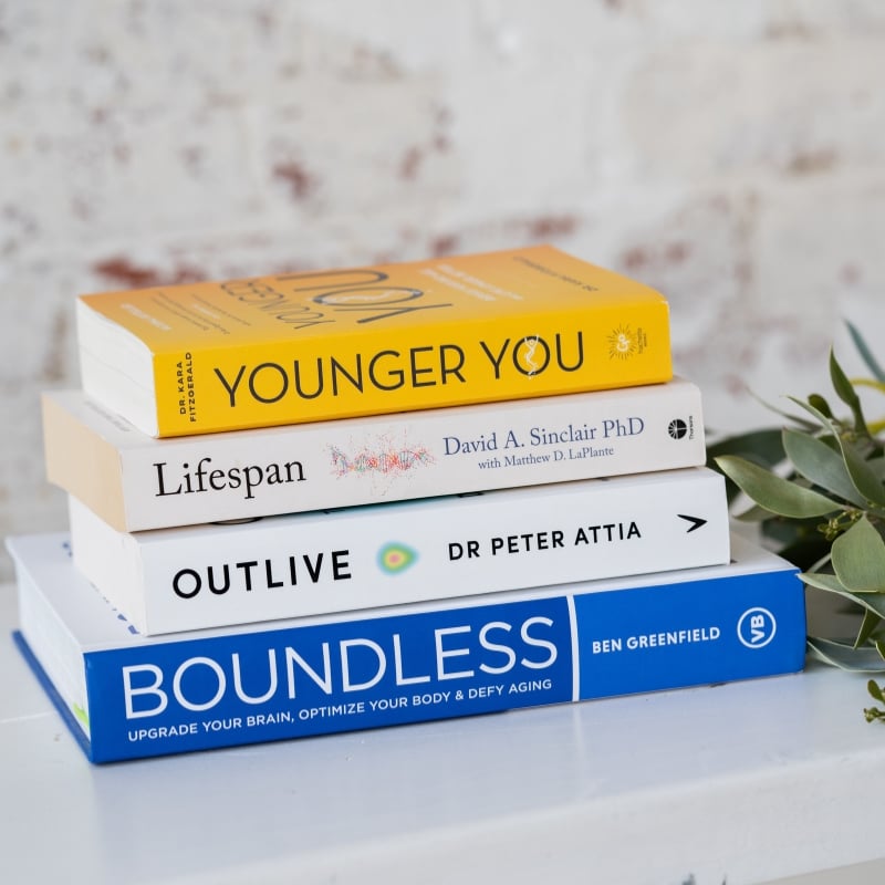 health-longevity-book-stack mark payne functional medicine practitioner chatting with liv brown health coach