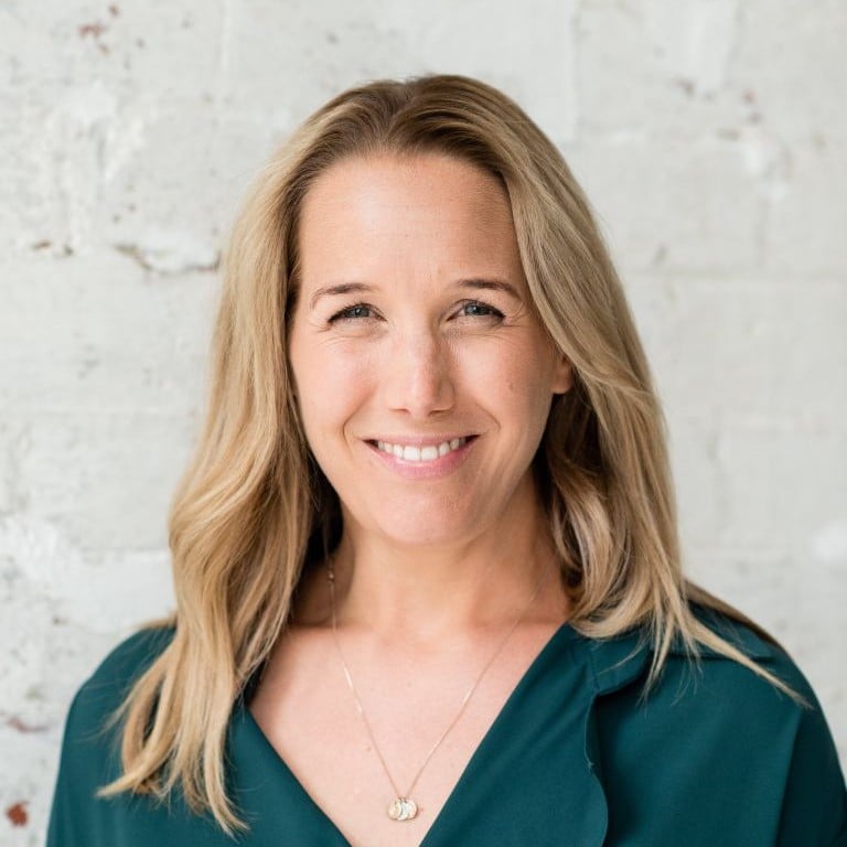 health coach jessica cairns wearing green top in front of white wall