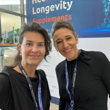 katia-dowling two women at a conference wearing lanyards