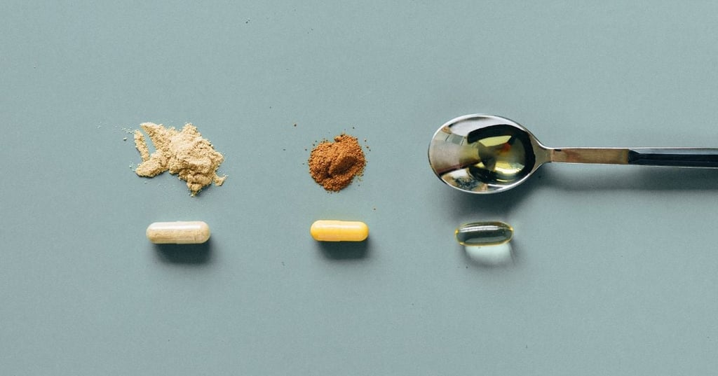 three capsules on benchtop with their contents displayed next to them