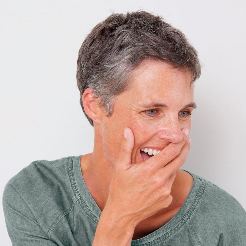 Photo of a woman with her hand over her mouth