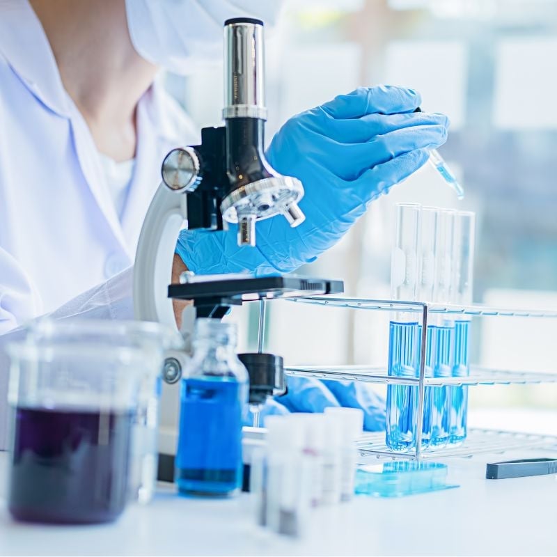 Scientist wearing blue gloves in a lab