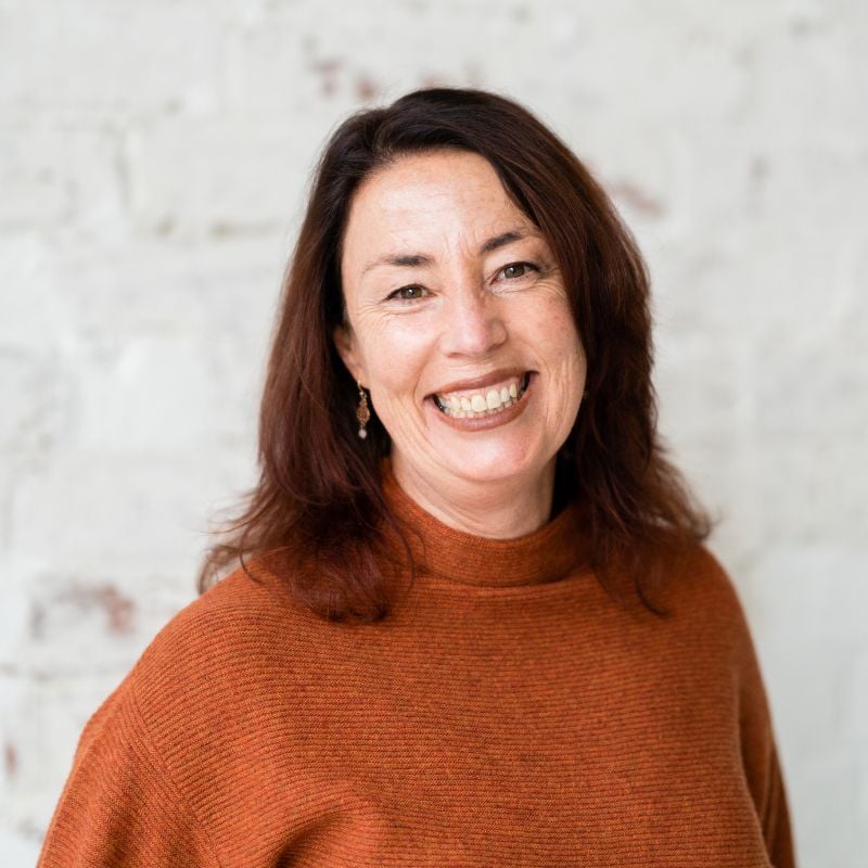 vicki van der meer functional medicine practitioner wearing rust coloured knit smiling